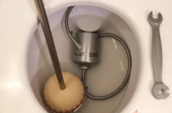 A clean bathroom featuring a sparkling toilet and tools positioned for maintenance.