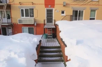 Snowy apartment complex with visible safety measures to prevent ice hazards, illustrating winter readiness.